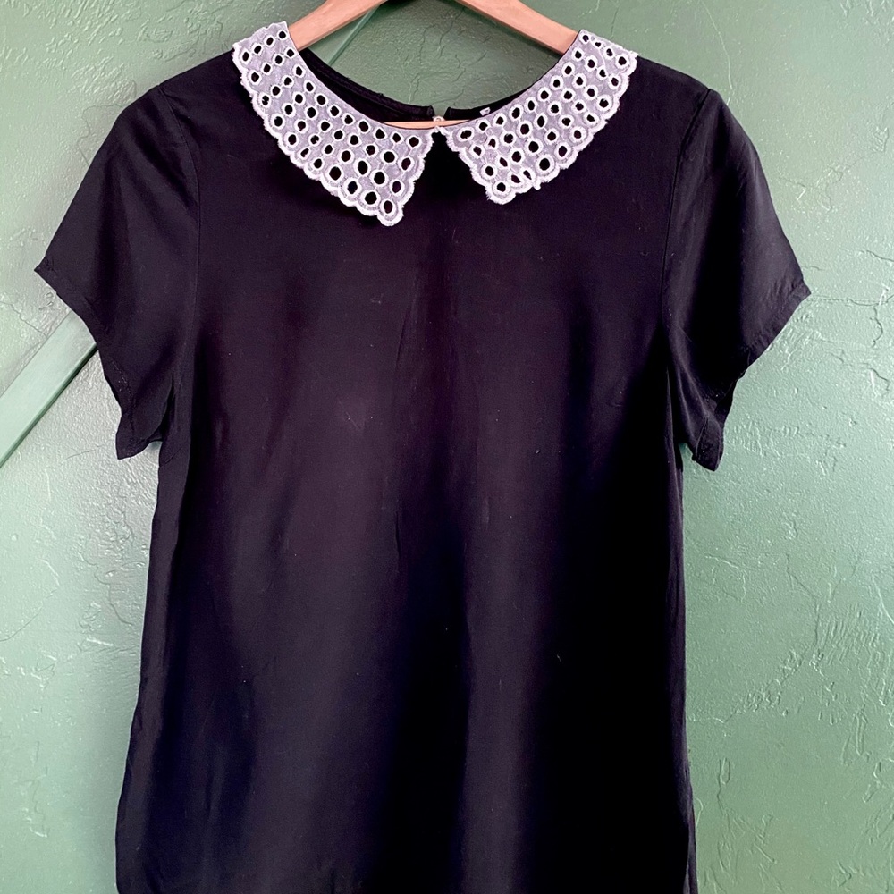 Black blouse with white detailed neckline